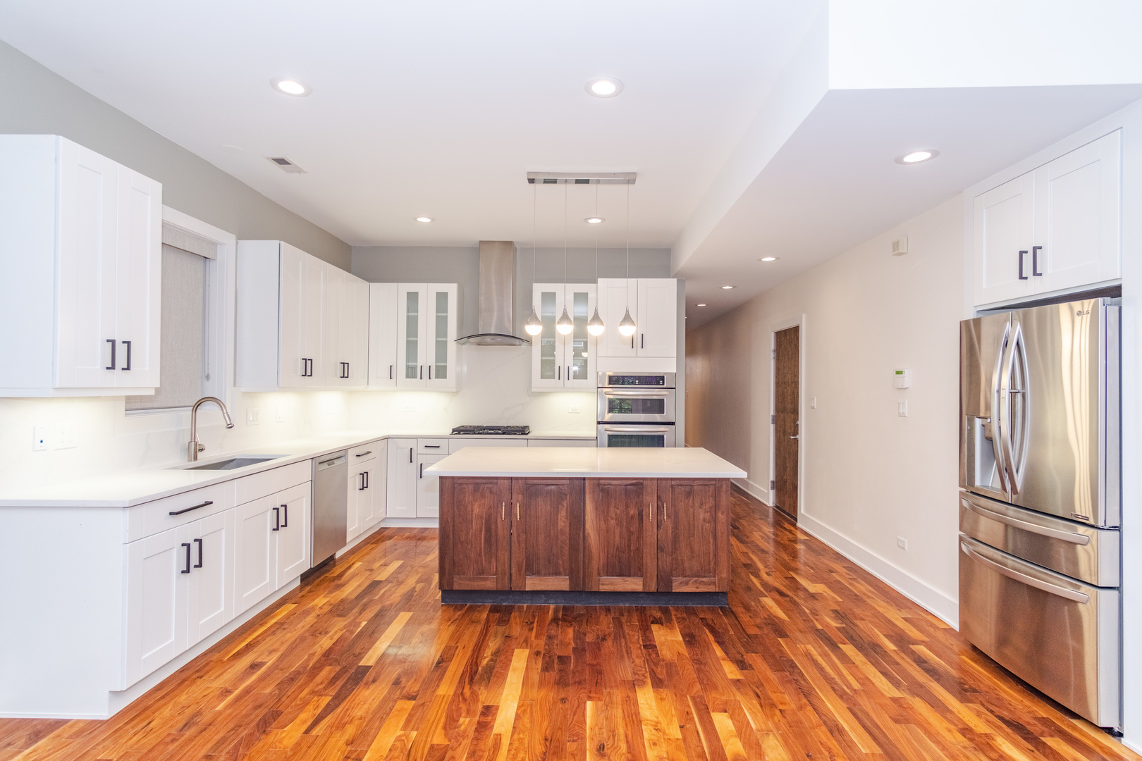 1242 West Jackson Boulevard, Unit 1W Chicago, IL 60607 - Photo 2 of 24 a large kitchen with stainless steel appliances granite countertop a large counter top a sink a refrigerator and a stove