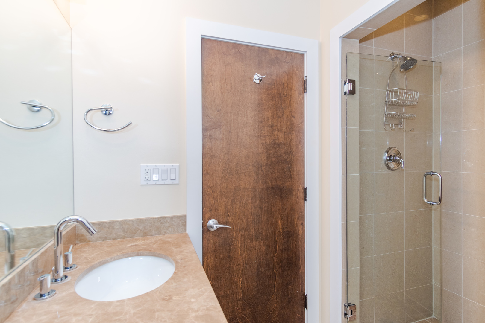 1242 West Jackson Boulevard, Unit 1W Chicago, IL 60607 - Photo 21 of 24 a bathroom with a granite countertop sink a mirror and shower