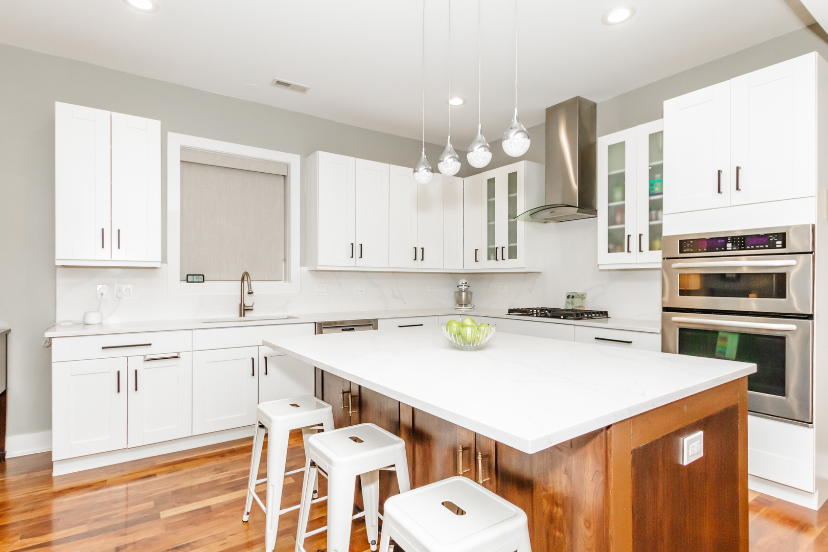1242 West Jackson Boulevard, Unit 1W Chicago, IL 60607 - Photo 3 of 24 a kitchen with a sink a stove cabinets and wooden floor