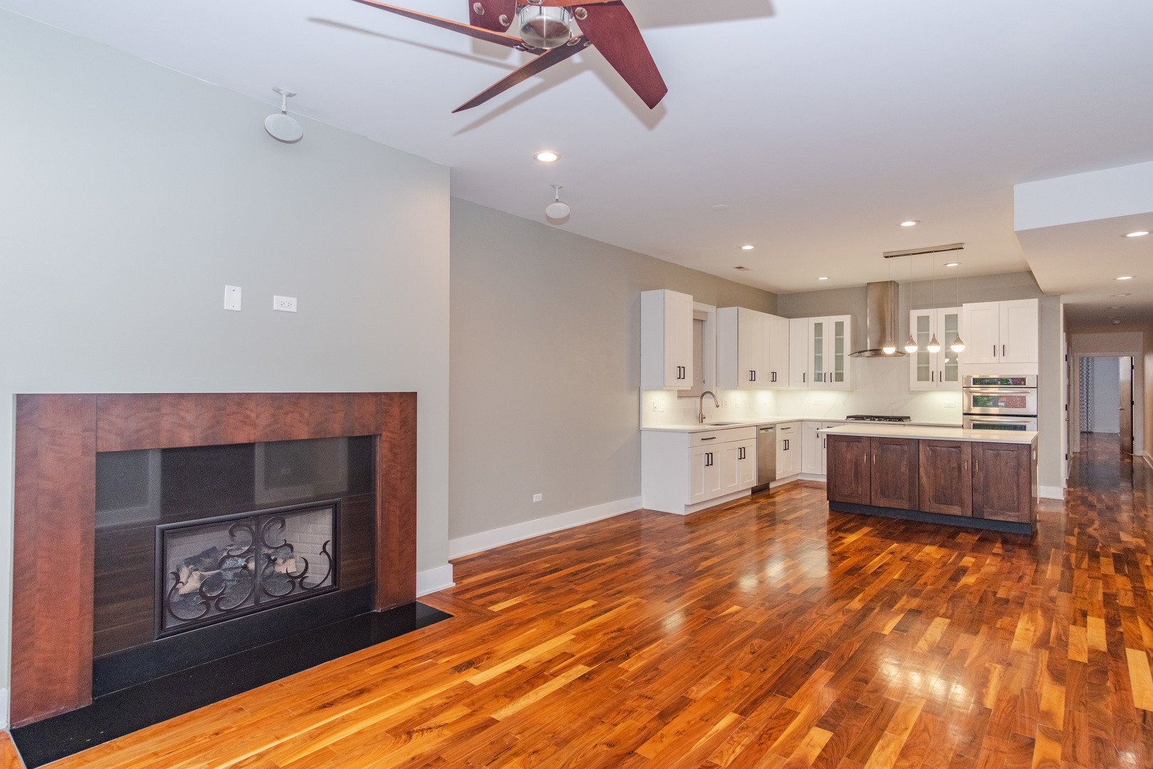 1242 West Jackson Boulevard, Unit 1W Chicago, IL 60607 - Photo 5 of 24 a large white kitchen with kitchen island a sink stainless steel appliances and cabinets