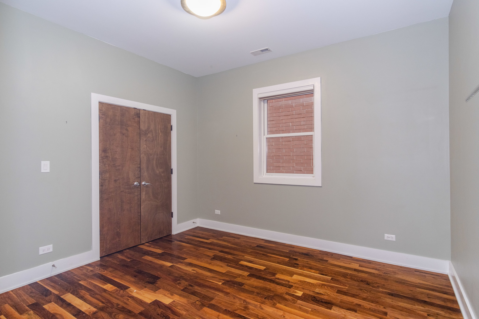 1242 West Jackson Boulevard, Unit 1W Chicago, IL 60607 - Photo 10 of 24 a view of a room with wooden floor and closet