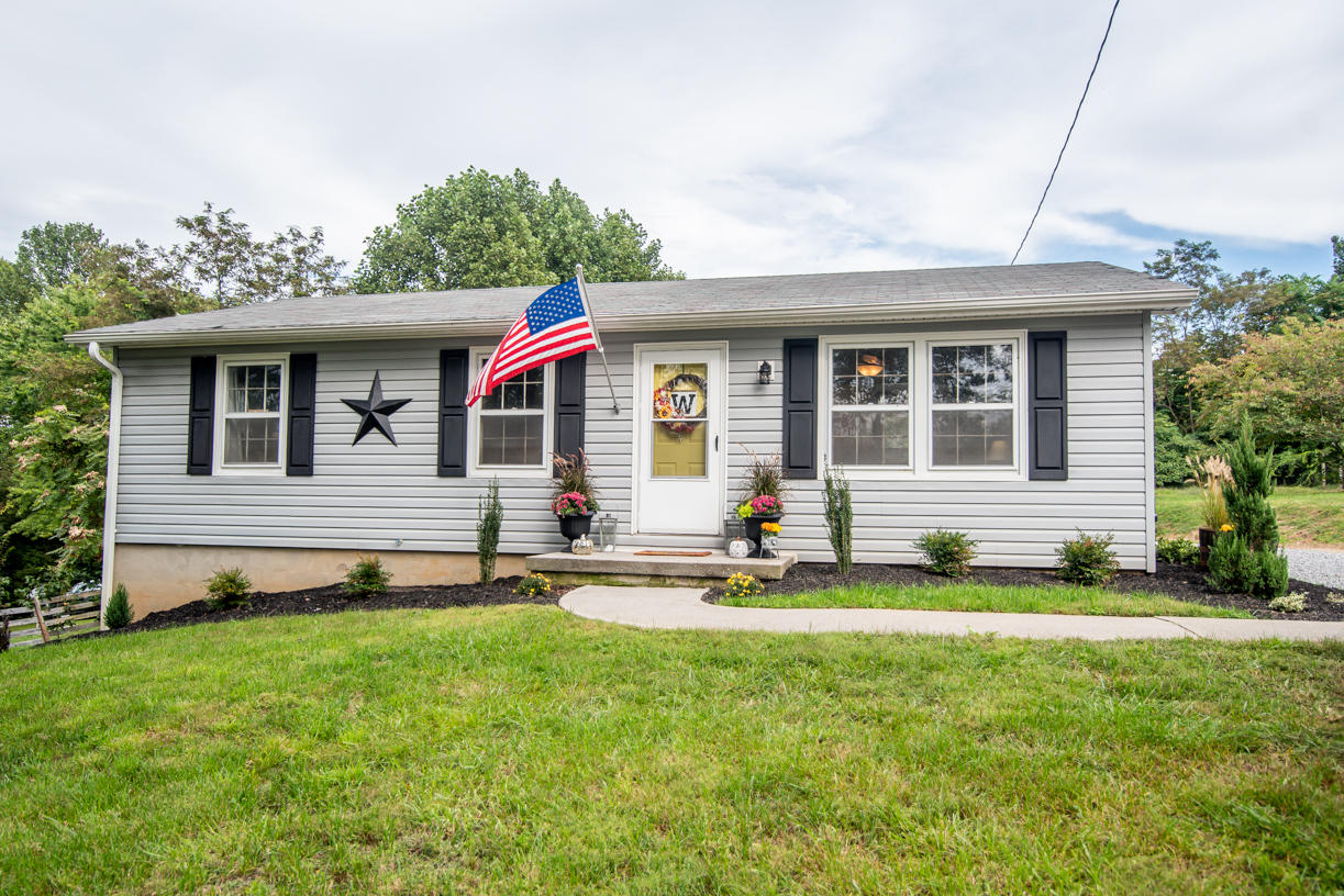 5556 Providence Church Road Ferrum, VA 24088 - Photo 50 of 74 a front view of a house with a yard and garage