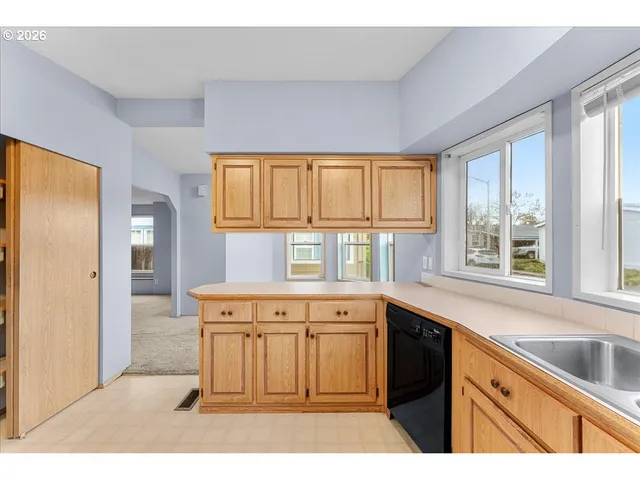 a kitchen with a stove a sink and a refrigerator