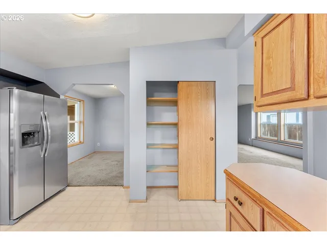 a kitchen with a refrigerator and a sink