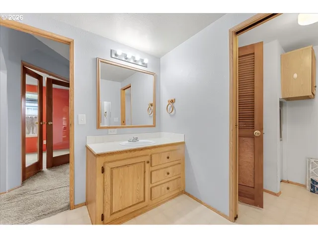 a bathroom with a granite countertop sink mirror and vanity