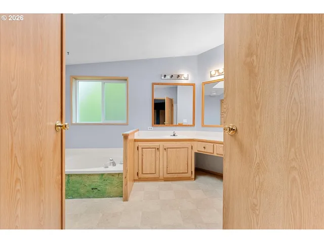 a bathroom with a sink vanity and mirror
