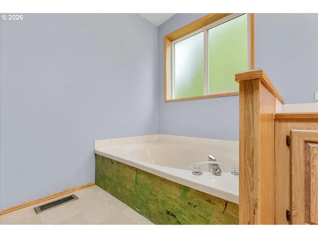 a bathroom with a bathtub and a window