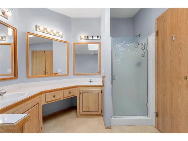 a spacious bathroom with a large mirror and a shower