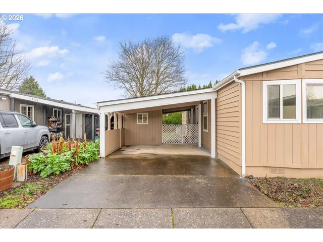 a view of a house with a yard and potted plants