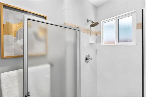 a bathroom with a glass shower door