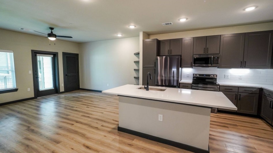 2953 Fm 2920 Rd Spring, Unit 4202 Spring, TX 77388 - Photo 8 of 36 a kitchen with kitchen island a stove and a sink