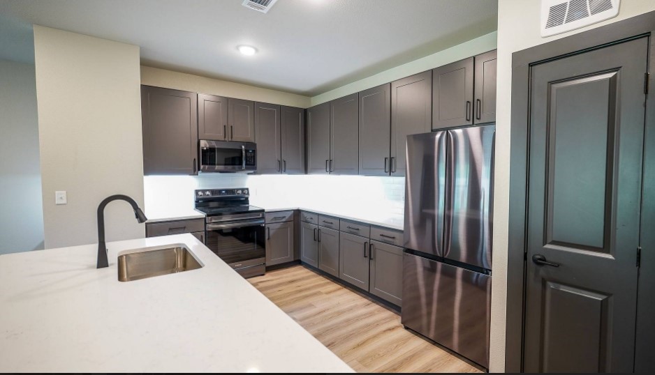 2953 Fm 2920 Rd Spring, Unit 4202 Spring, TX 77388 - Photo 10 of 36 a kitchen with kitchen island a counter top space cabinets and stainless steel appliances