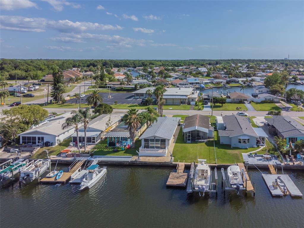 4609 Floramar Terrace New Port Richey, FL 34652 - Photo 1 of 1 an aerial view of residential houses with outdoor space and lake view