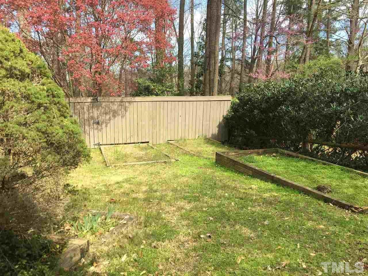 2757 Rue Sans Famille Raleigh, NC 27607 - Photo 20 of 21 a view of a backyard with large trees