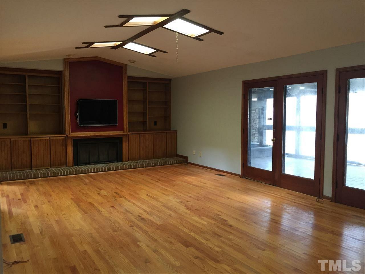 2757 Rue Sans Famille Raleigh, NC 27607 - Photo 7 of 21 a view of empty room with wooden floor and fan