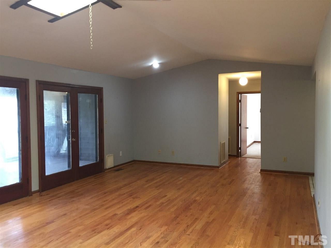 2757 Rue Sans Famille Raleigh, NC 27607 - Photo 8 of 21 a view of an empty room with wooden floor and a window