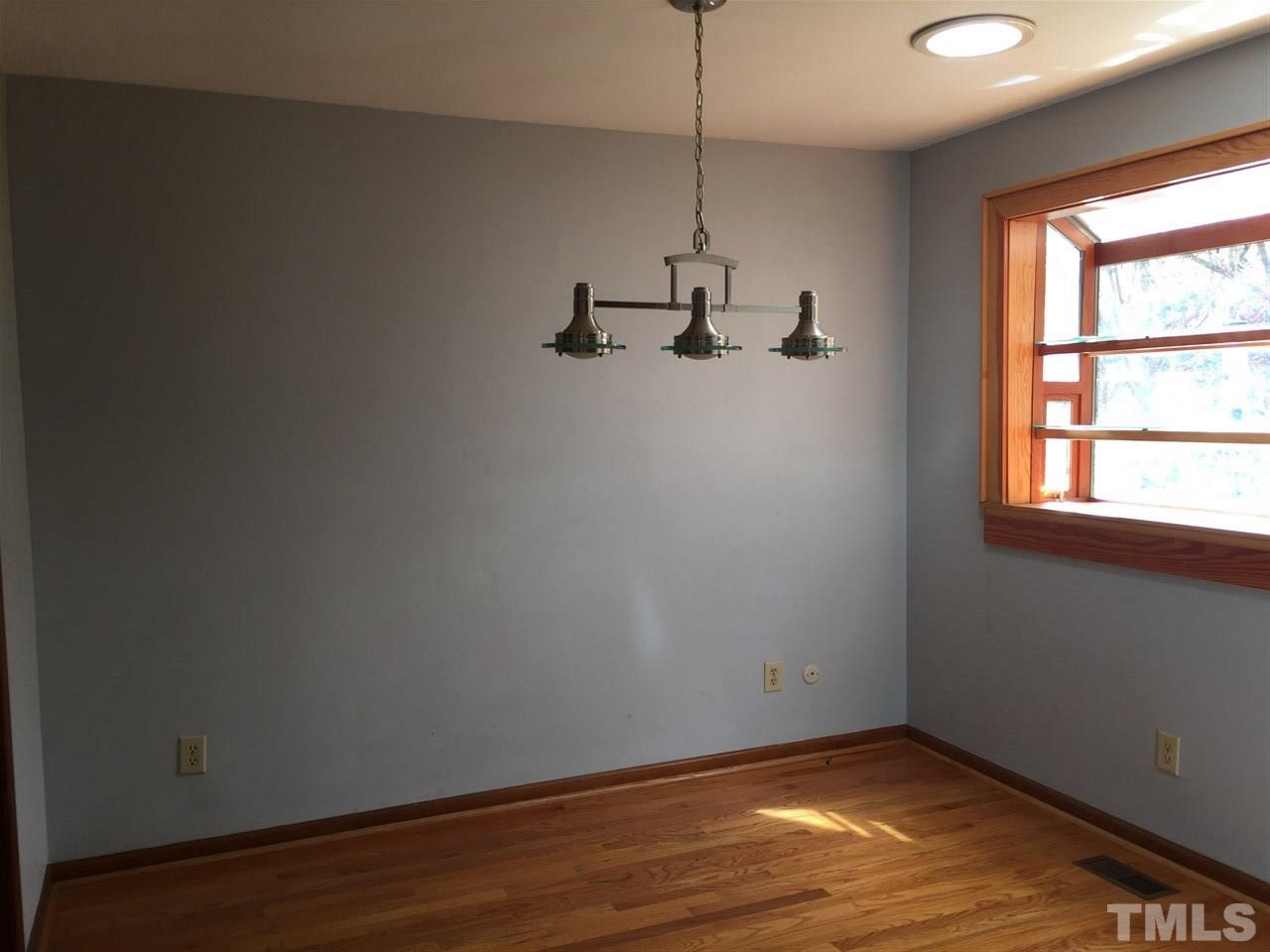 2757 Rue Sans Famille Raleigh, NC 27607 - Photo 10 of 21 a view of a room with wooden floor closet and windows
