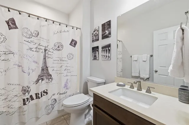 a bathroom with a sink toilet and a mirror