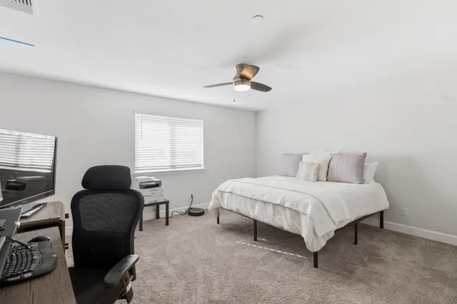 a bedroom with a bed and chair