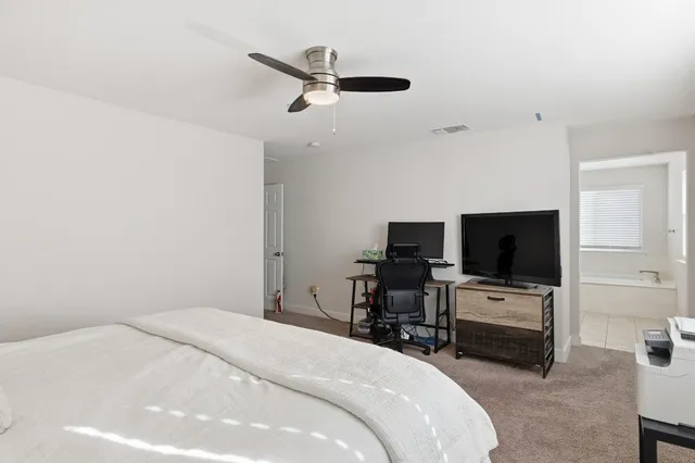 a bedroom with a bed and a flat screen tv
