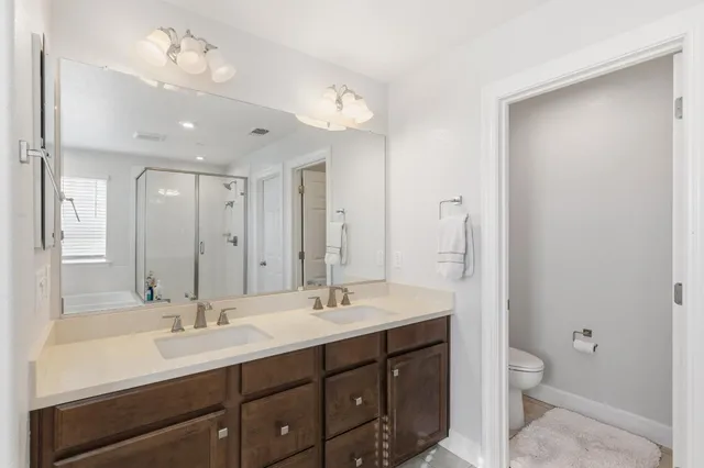 a bathroom with a double vanity sink mirror and double