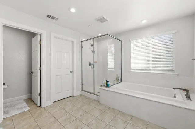 a spacious bathroom with a bathtub and a shower