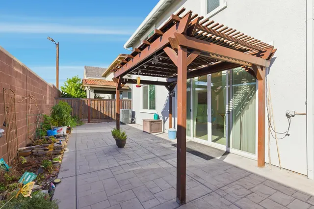 a view of a house with a yard and furniture