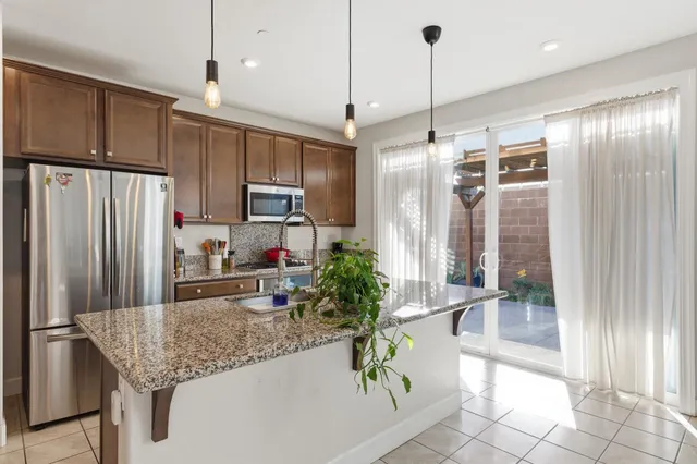 a kitchen with refrigerator and microwave