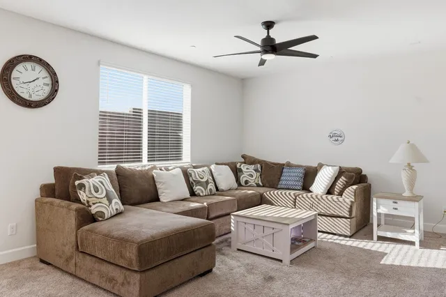 a living room with furniture and a large window