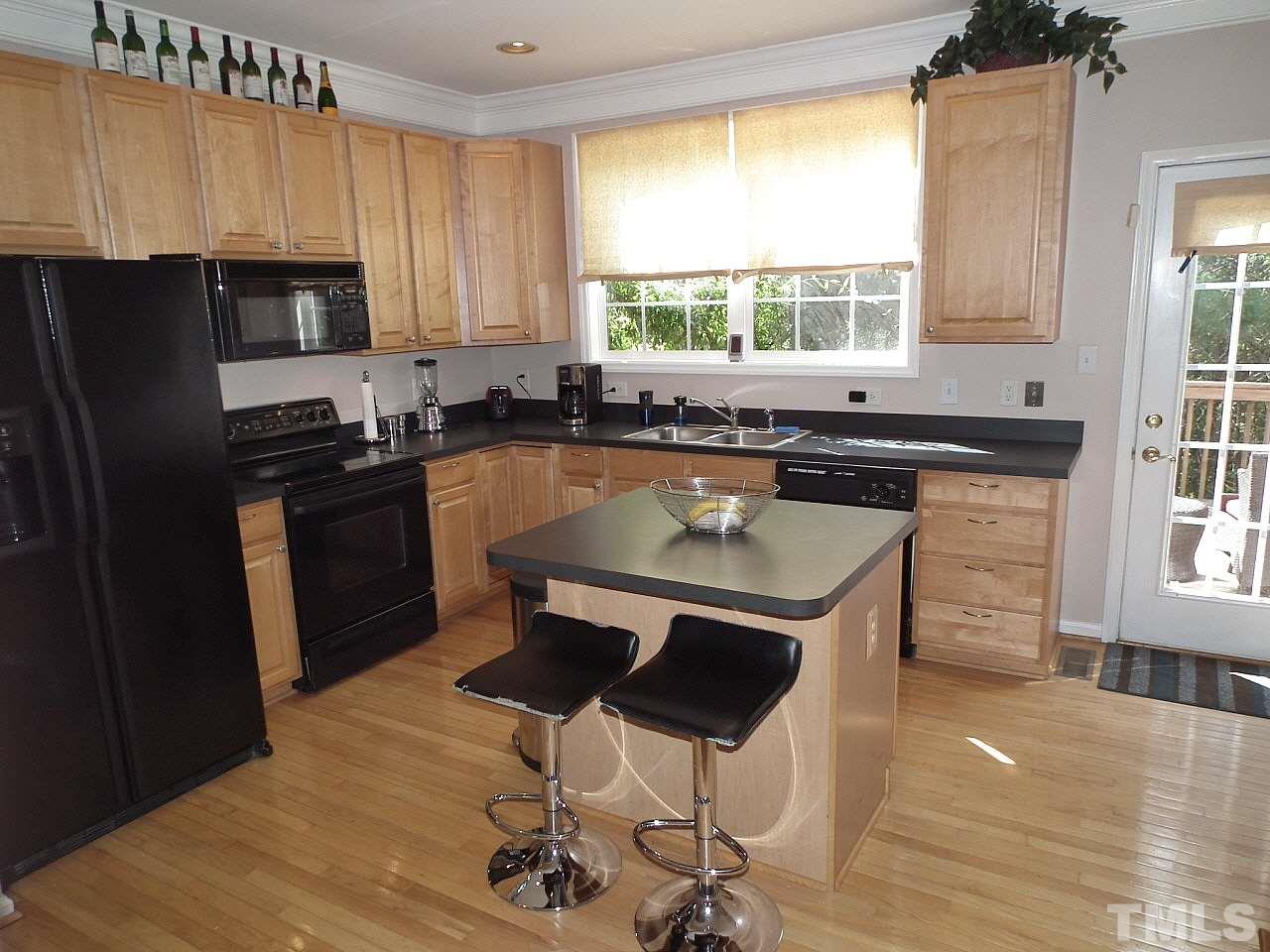 5318 Echo Ridge Road Raleigh, NC 27612 - Photo 2 of 25 a kitchen with a stove a refrigerator and a sink