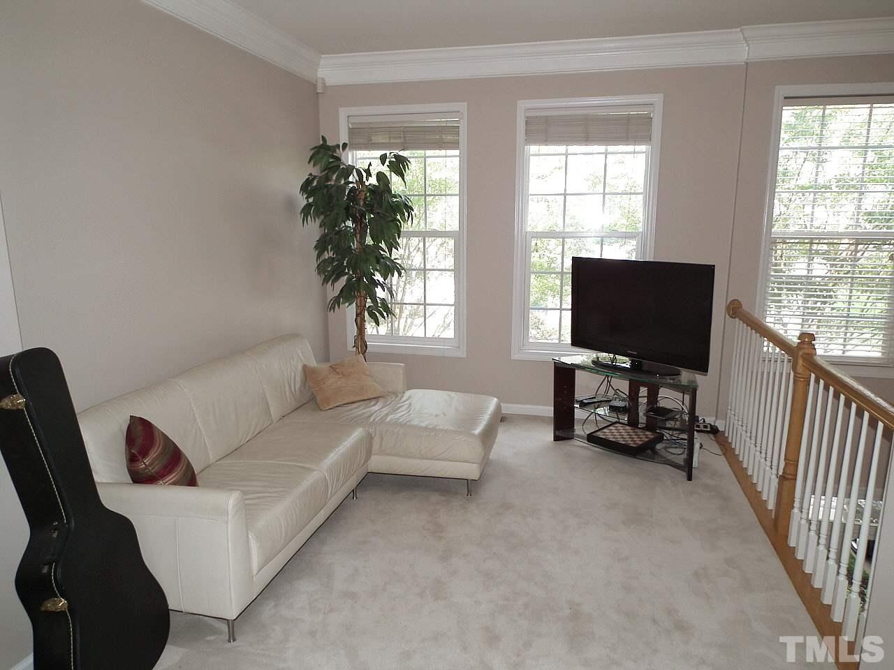 5318 Echo Ridge Road Raleigh, NC 27612 - Photo 12 of 25 a living room with furniture and a flat screen tv