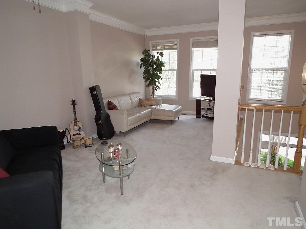 5318 Echo Ridge Road Raleigh, NC 27612 - Photo 13 of 25 a living room with furniture and a flat screen tv