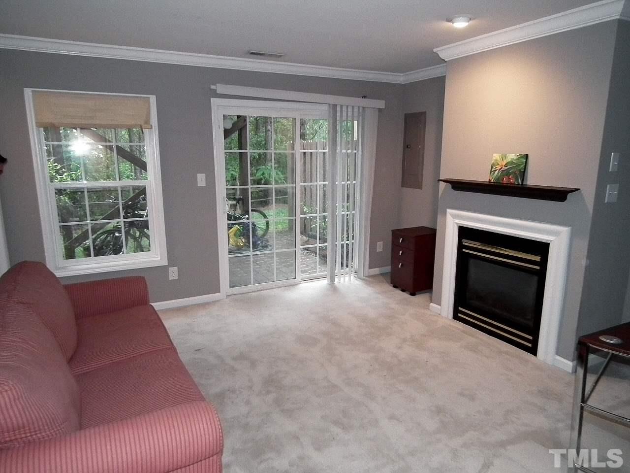 5318 Echo Ridge Road Raleigh, NC 27612 - Photo 15 of 25 a living room with furniture and a fireplace