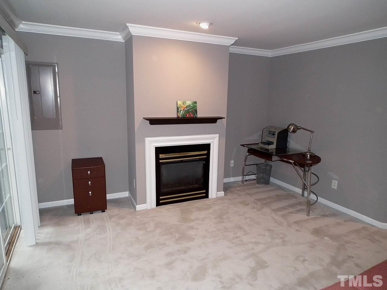 5318 Echo Ridge Road Raleigh, NC 27612 - Photo 16 of 25 a living room with furniture and a fireplace