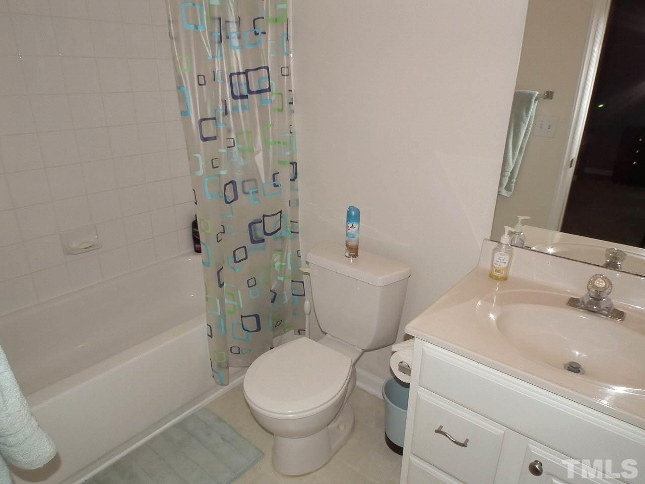 5318 Echo Ridge Road Raleigh, NC 27612 - Photo 17 of 25 a white toilet sitting next to a bath tub