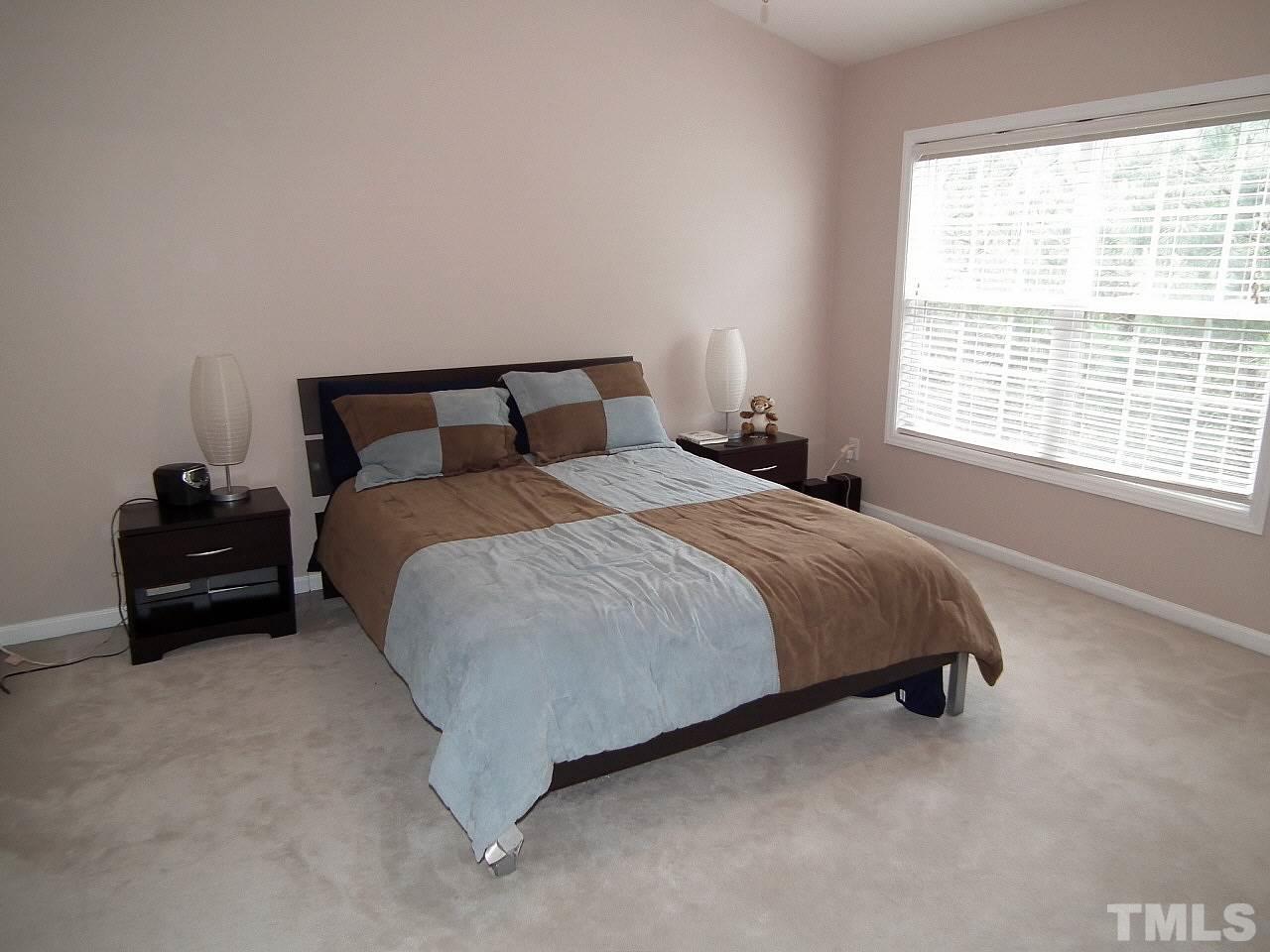 5318 Echo Ridge Road Raleigh, NC 27612 - Photo 19 of 25 a bed sitting in a bedroom next to a window