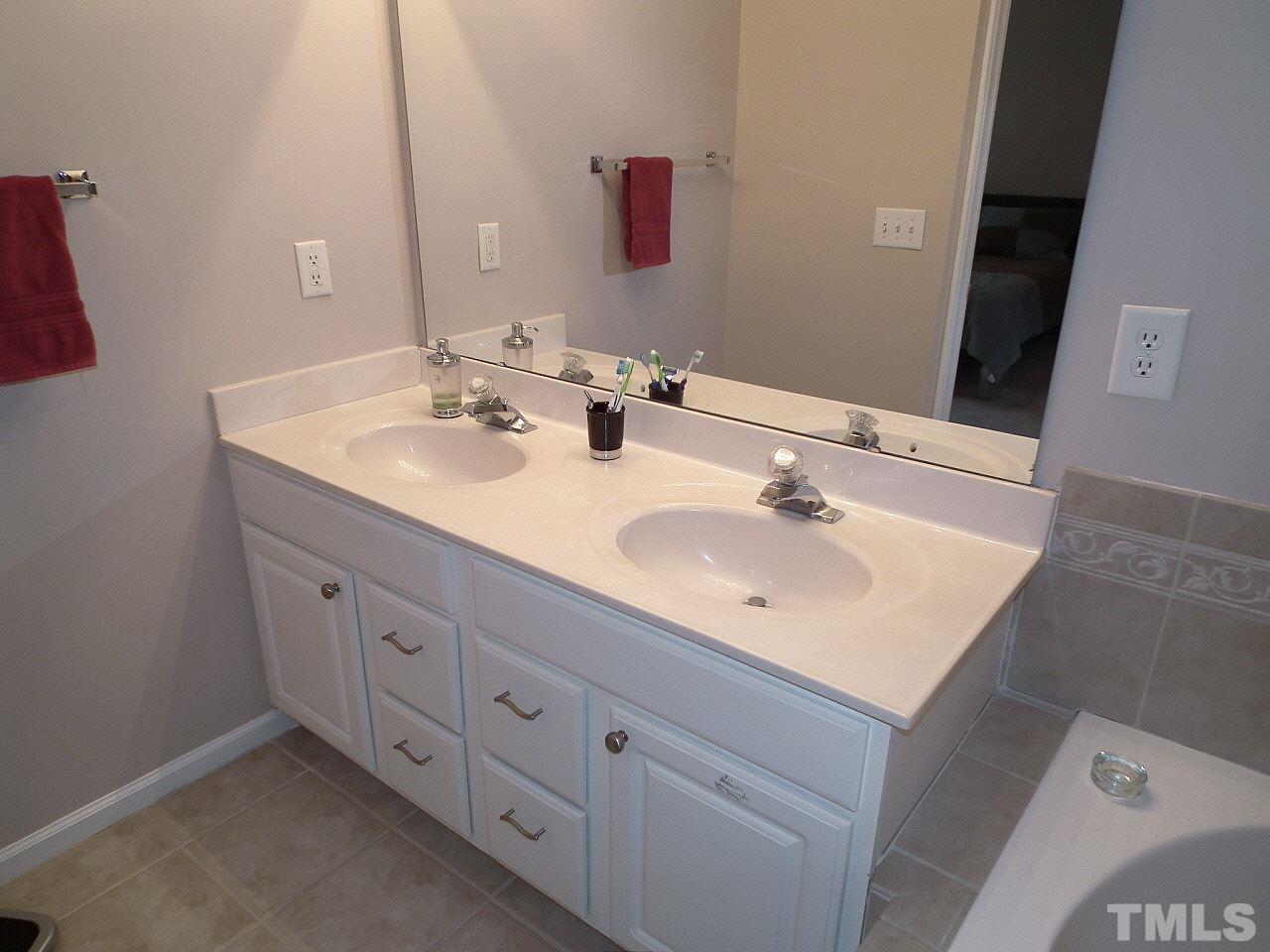 5318 Echo Ridge Road Raleigh, NC 27612 - Photo 20 of 25 a bathroom with double sink and two mirror