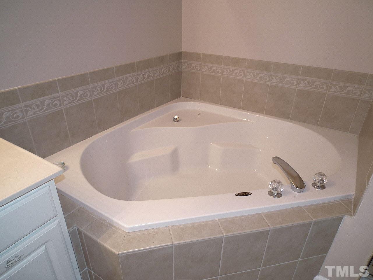 5318 Echo Ridge Road Raleigh, NC 27612 - Photo 22 of 25 a bath tub sitting in a bathroom