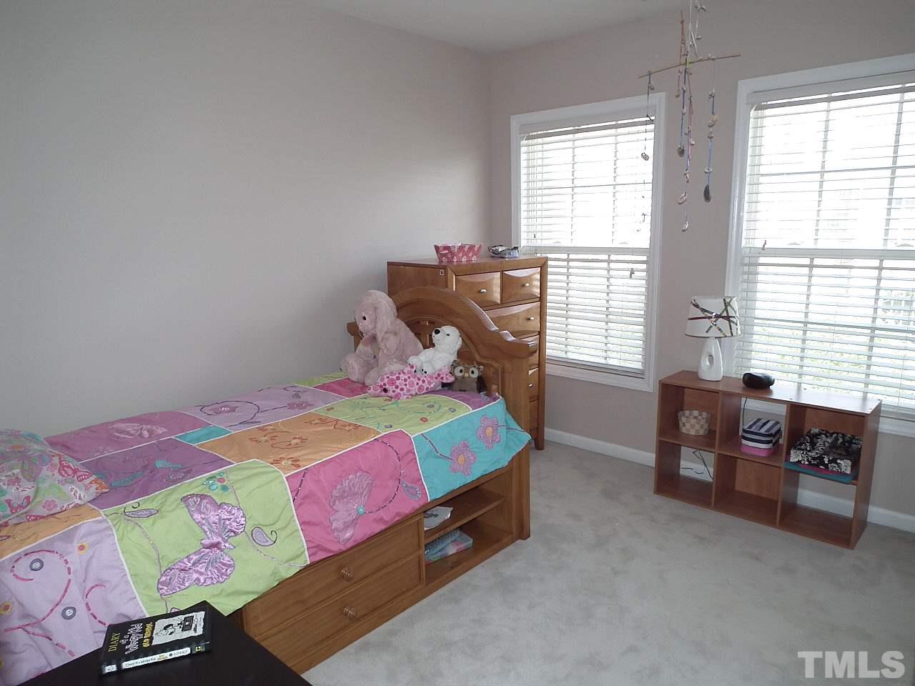 5318 Echo Ridge Road Raleigh, NC 27612 - Photo 23 of 25 a bedroom with a bed and a window
