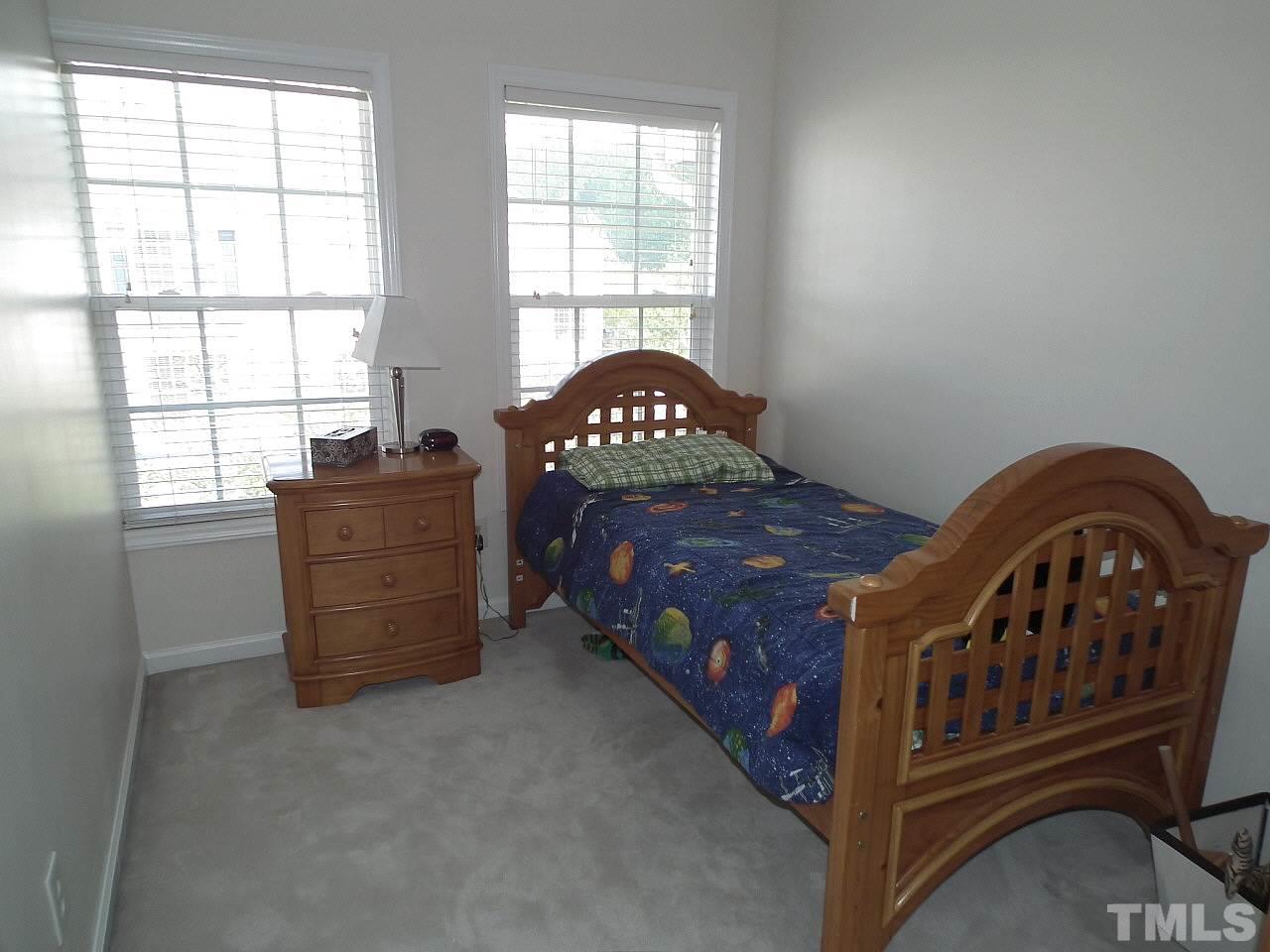 5318 Echo Ridge Road Raleigh, NC 27612 - Photo 24 of 25 a bedroom with a bed next to a window