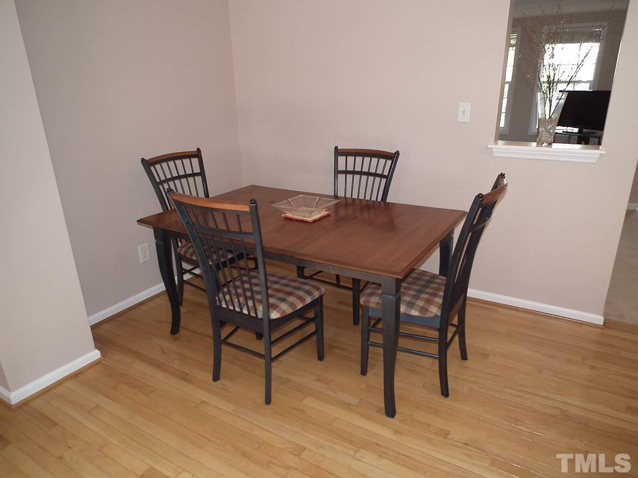 5318 Echo Ridge Road Raleigh, NC 27612 - Photo 4 of 25 a view of a dining room with furniture and wooden floor