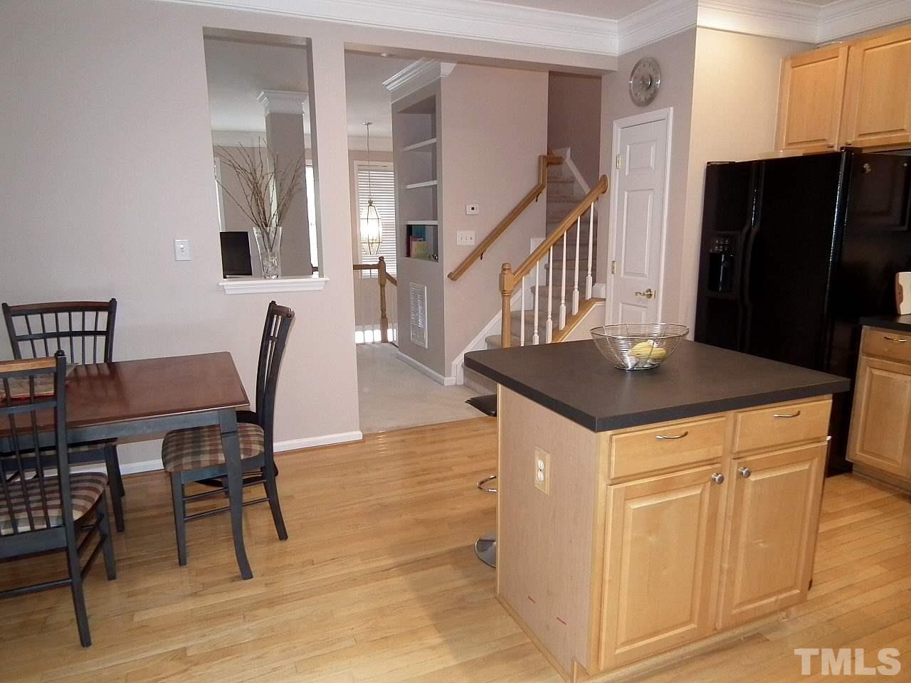5318 Echo Ridge Road Raleigh, NC 27612 - Photo 7 of 25 a view of a dining room with furniture and wooden floor