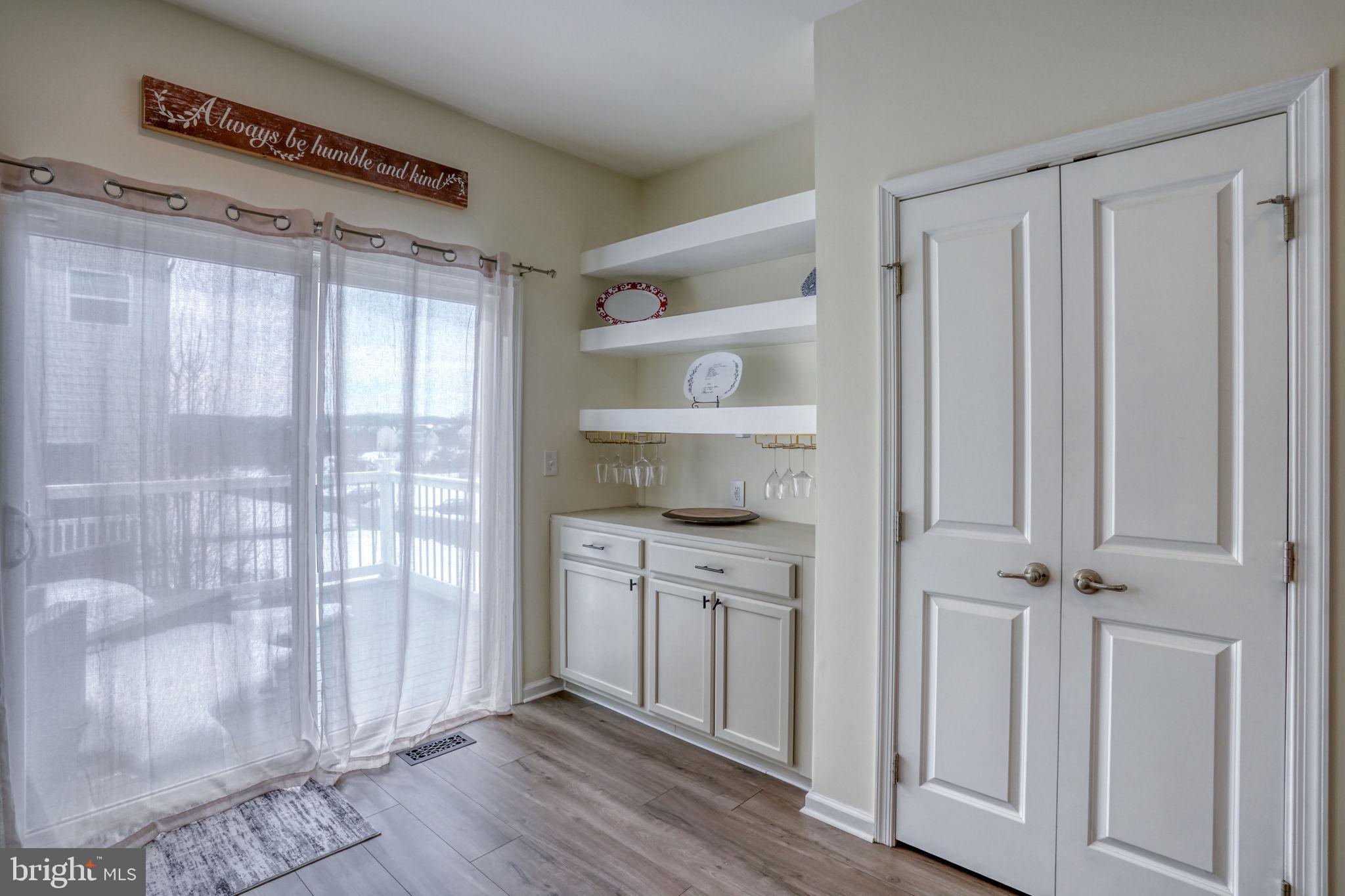 602 Barrie Road Middletown, DE 19709 - Photo 14 of 35 a view of a kitchen with white cabinets and wooden floor