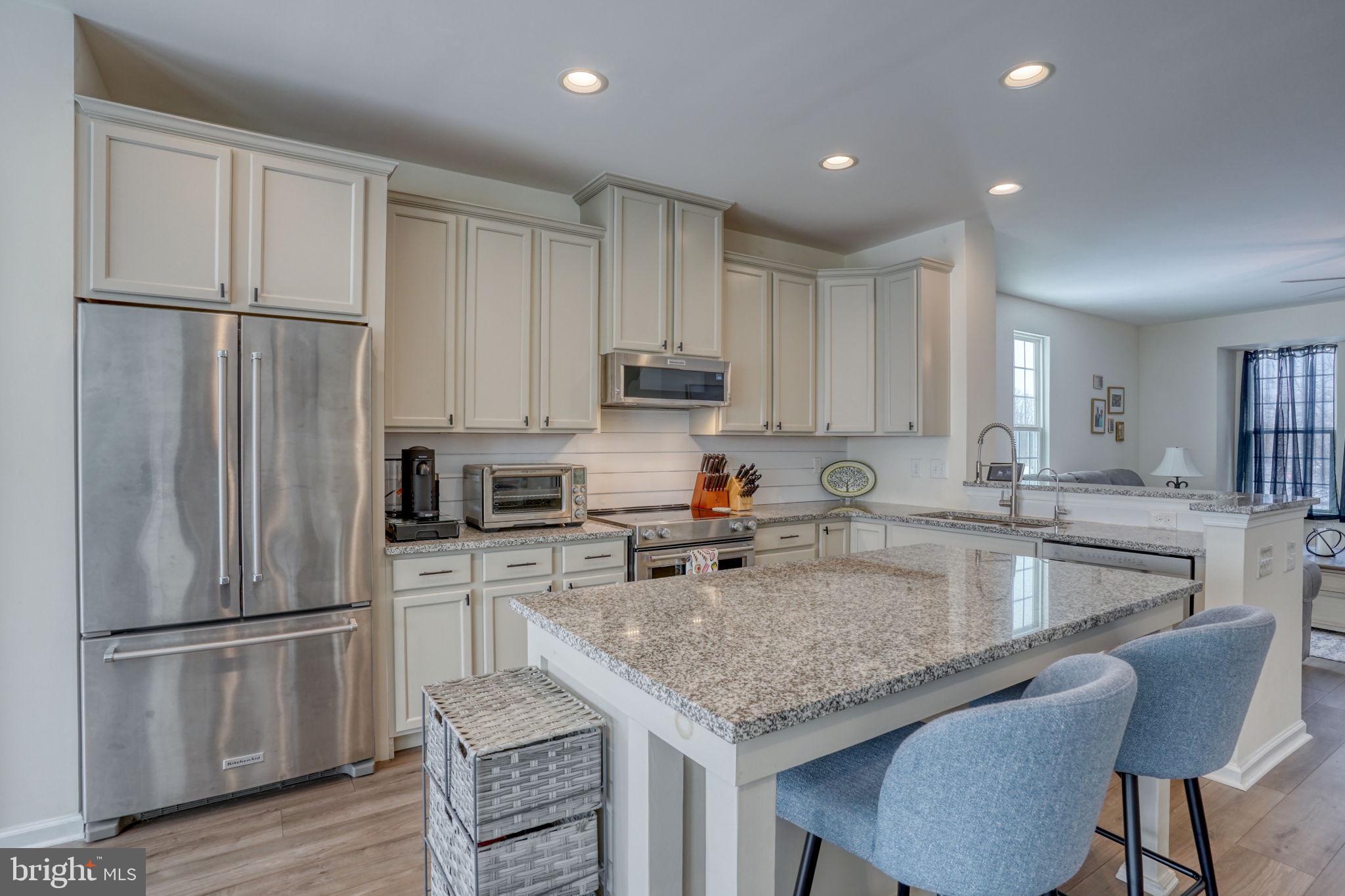 602 Barrie Road Middletown, DE 19709 - Photo 15 of 35 a kitchen with a refrigerator a sink and white cabinets