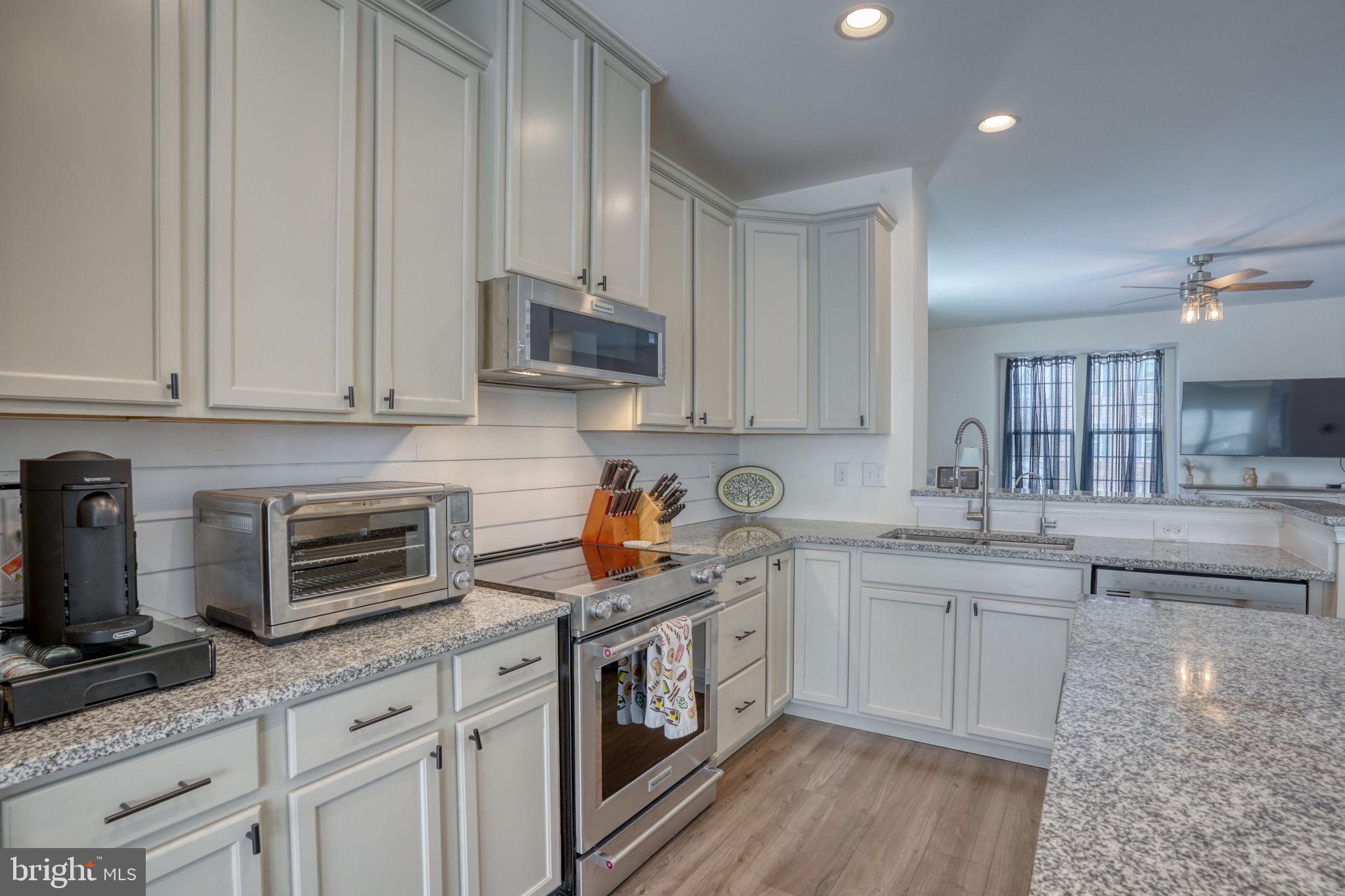 602 Barrie Road Middletown, DE 19709 - Photo 16 of 35 a kitchen with stainless steel appliances granite countertop a sink stove and cabinets