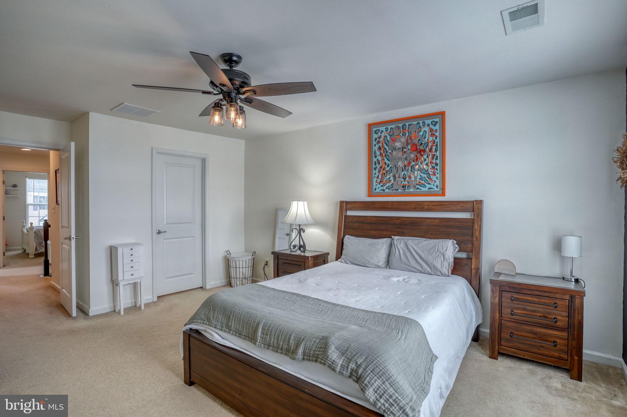 602 Barrie Road Middletown, DE 19709 - Photo 17 of 35 a bedroom with a bed and a chandelier
