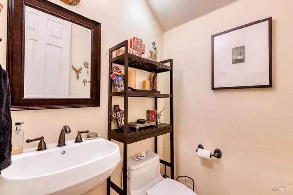a bathroom with a toilet a sink and mirror