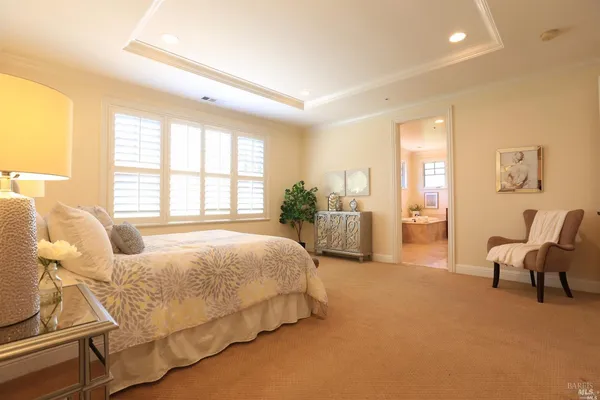 a spacious bedroom with a bed and large windows