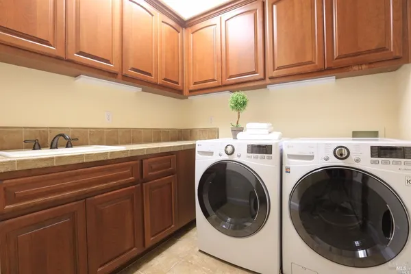a utility room with sink dryer and washer