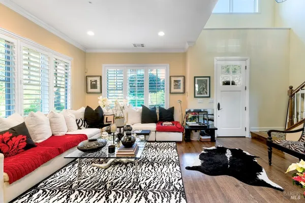 a bedroom with furniture and a large window